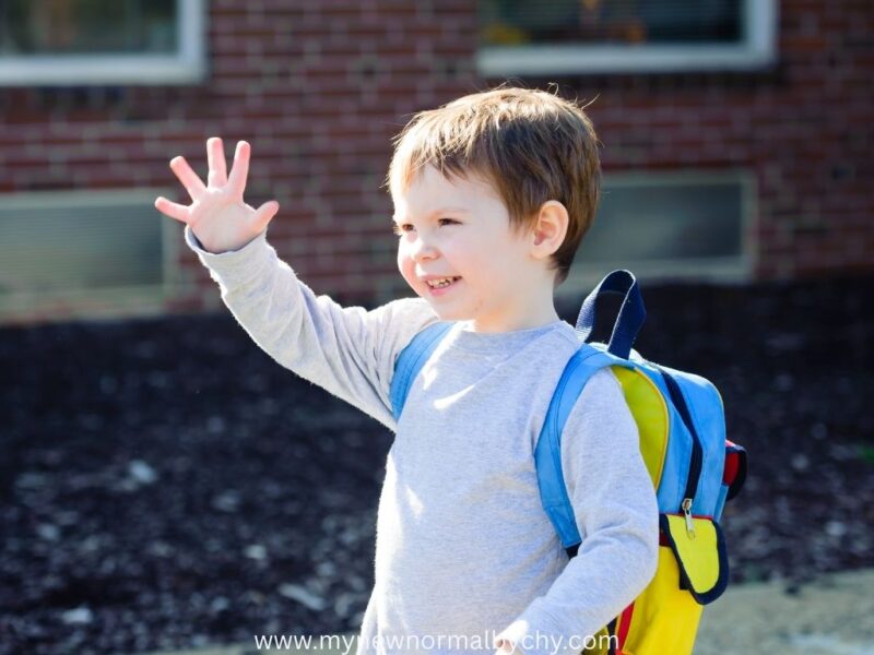 happy-toddler-waving-on-first-school-day