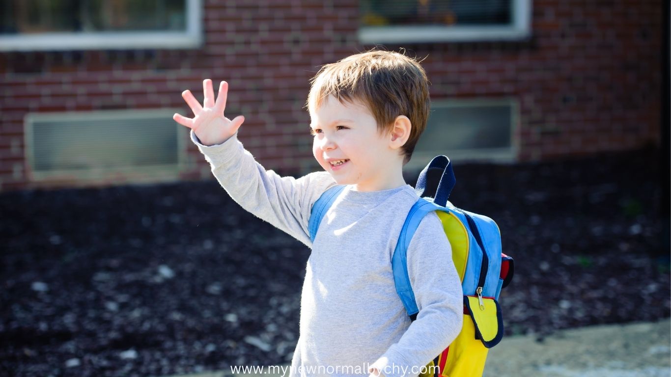 happy-toddler-waving-on-first-school-day