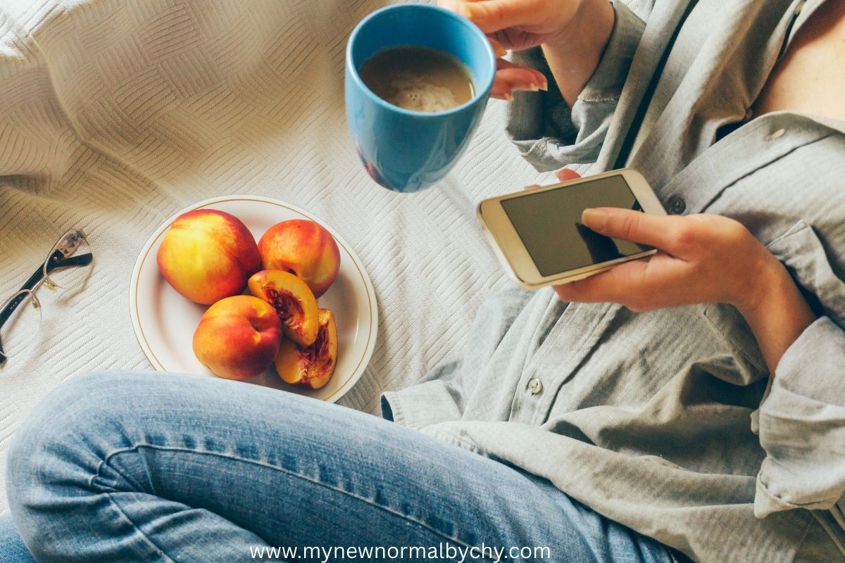 a-woman-eating-apples-and-drinking-coffee-while-pressing-her-phone-time-management-tips-for-stay-at-home-moms
