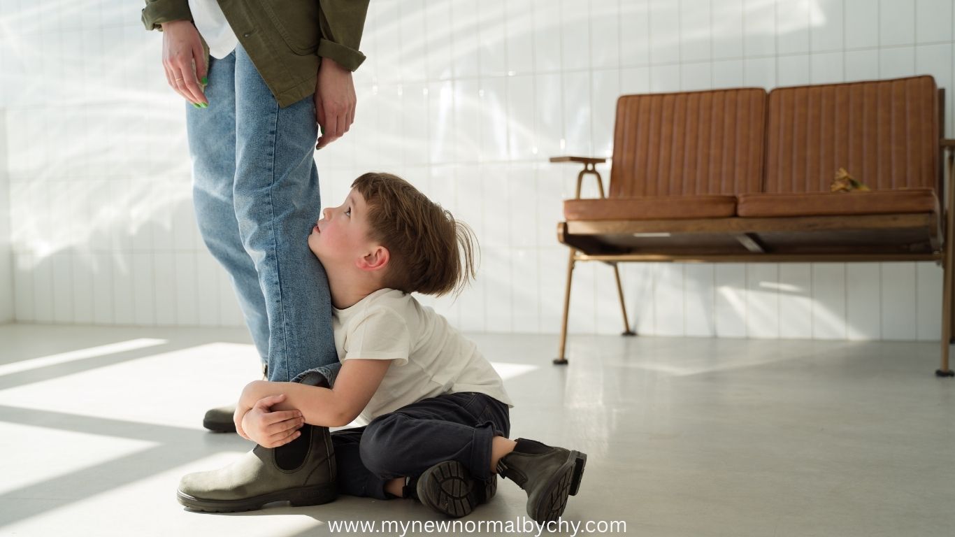 a-boy-on-the-floor-hugging-a-mans-legs