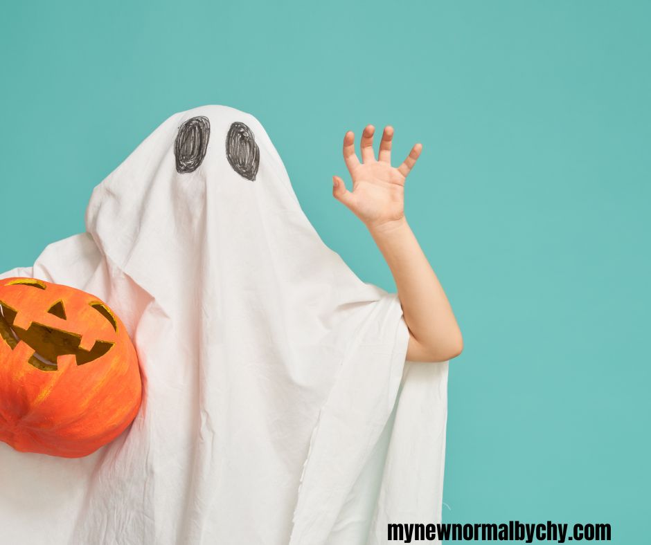 a-kid-wearing-a-bedsheet-costume-and-carrying-a-big-pumkin-for-15-DIY-halloween-costumes-you-can-create-on-a-budget
