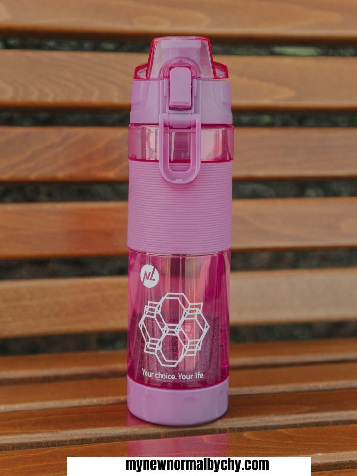 a-pink-water-bottle-on-a-rustic-table