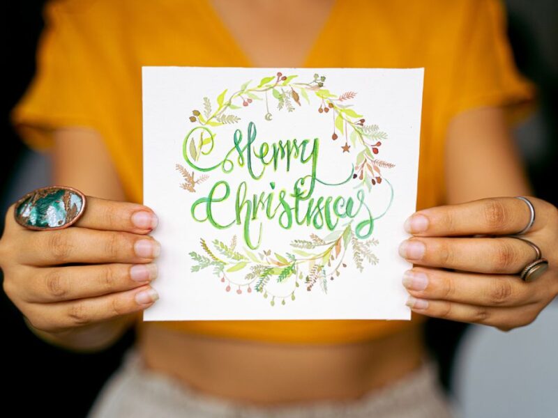 a-photo-of-a-woman-holding-a-Christmas-greeting-card