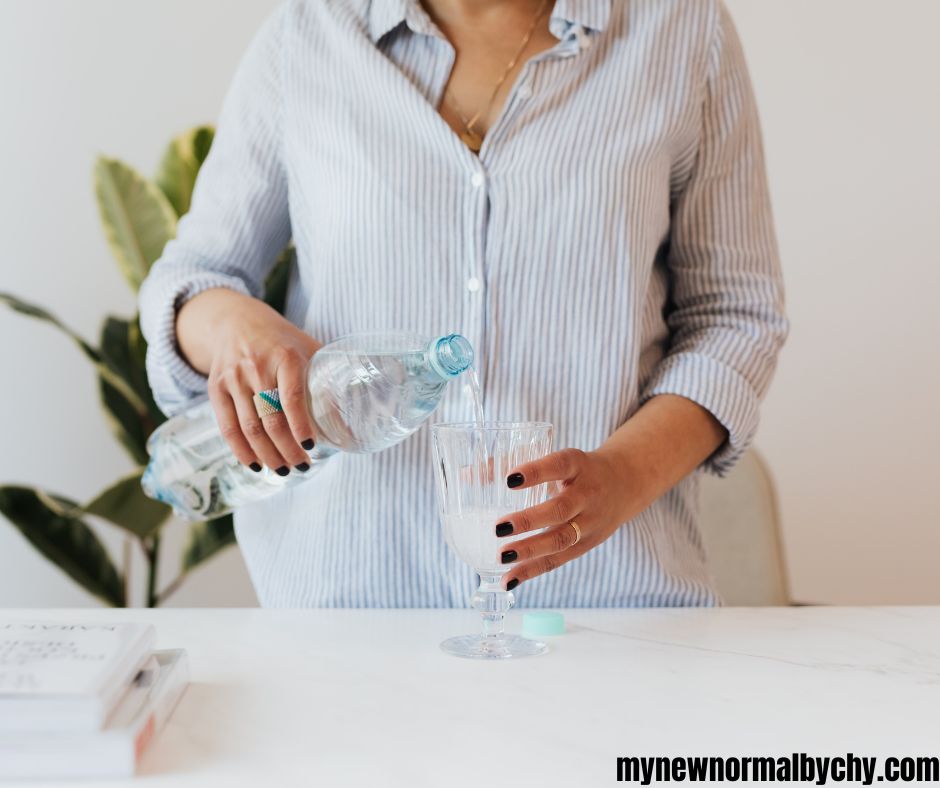a-woman-pouring-water-into-a-glass-cup-10-Most-Effective-Natural-Ways-to-Boost-Your-Milk-Supply