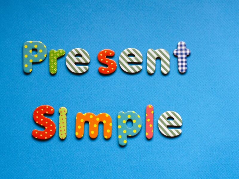 coloured-text-present-simple-on-blue-paper-background