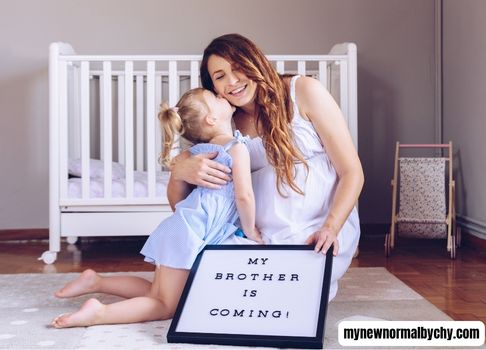 A-picture-of-a-pregnant-mom-and-her-toddler-in-the-nursery