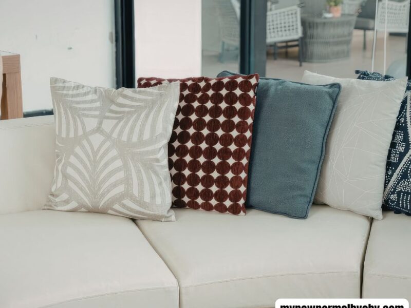 a-living-room-with-a-sofa-and-some-differently-designed-throw-pillows-How-to-Mix-and-Match-Throw-Pillow-Combinations-for-a-Cozy-Living-Room