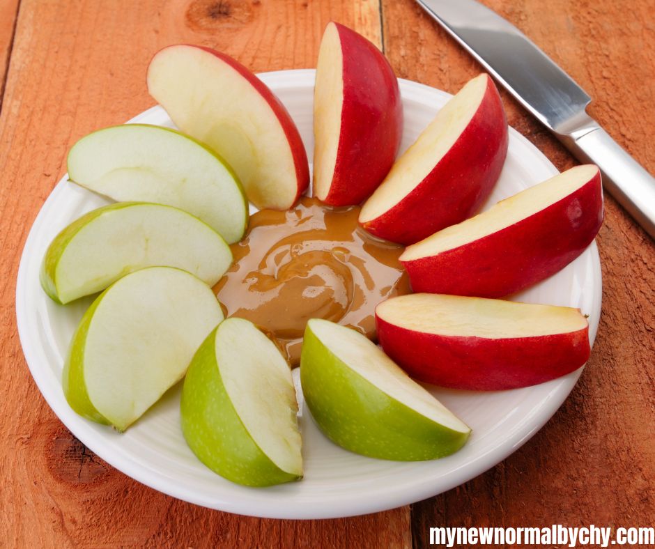 An-overhead-shot-of-sliced-green-and-red-apple-with-peanut-butter
