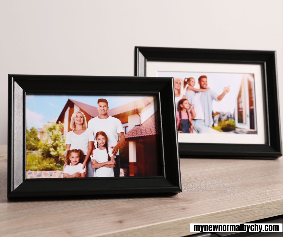 Two-framed-family-photos-on-a-wooden-table