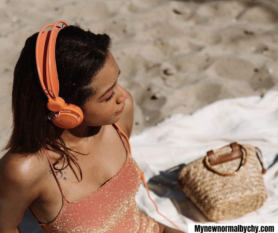 young-woman-listening to music-in-an-outdoor-setting15-Simple-Summer-Self-Care-Ideas-for-Bus- Moms