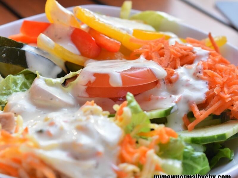 close-up-shot-of-a-colourful-salad-bowl-with-yoghurt-topping