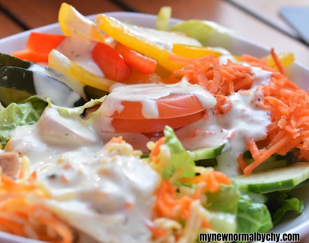close-up-shot-of-a-colourful-salad-bowl-with-yoghurt-topping