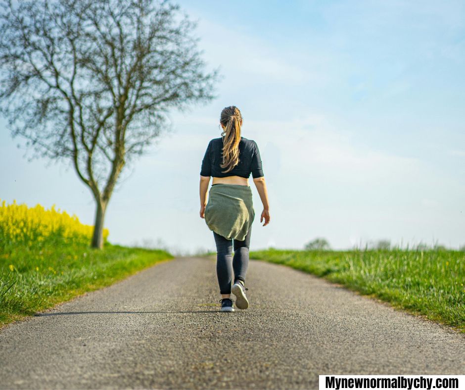An-image-of-a-woman-snapped-from-behind-while-she-is-taking-a-walk-15-Simple-Summer-Self-Care-ideas-for-Busy-Moms