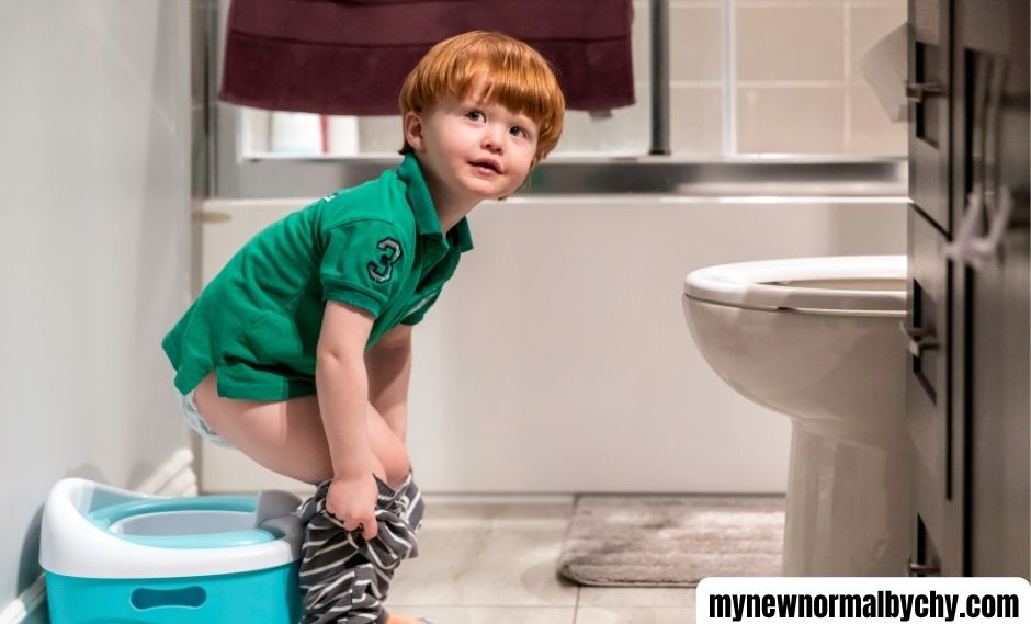 a-toddler-boy-pulling-down-his-pants-to-use-the-potty